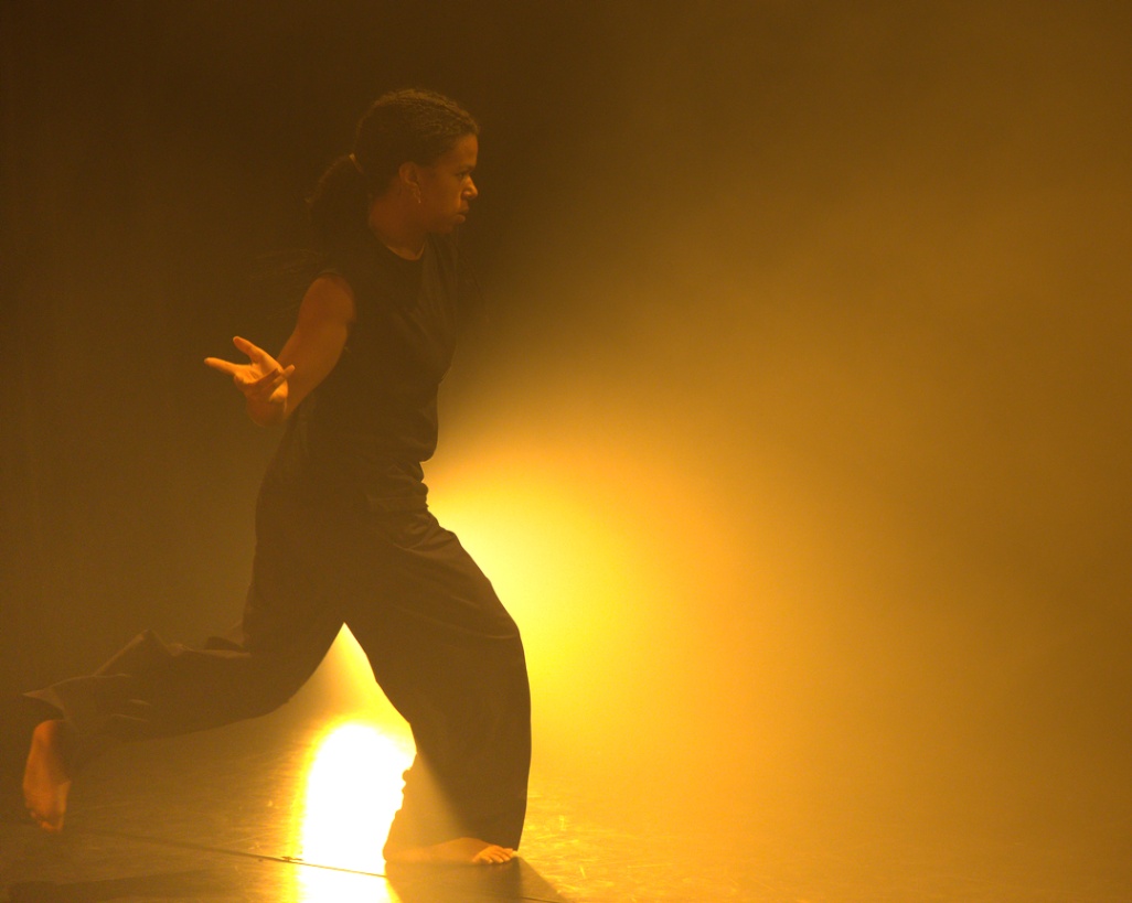 danseuse qui marche dans la lumière sur un plateau en résidence